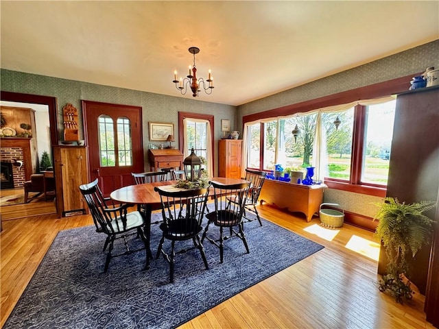 225 John Cook Rd, Unadilla, NY 13849 - dining room with wallpapered walls, wood-type flooring, healthy amount of natural light, and a chandelier