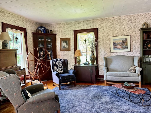 225 John Cook Rd, Unadilla, NY 13849 - sitting room with plenty of natural light, wood finished floors, ornamental molding, and wallpapered walls
