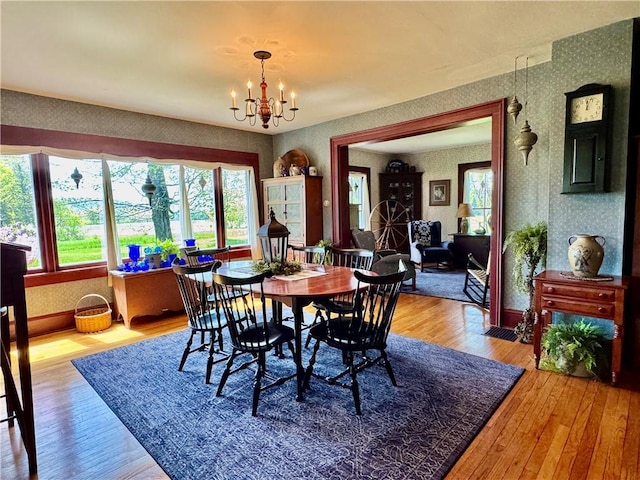 225 John Cook Rd, Unadilla, NY 13849 - dining space with wallpapered walls, a chandelier, wood-type flooring, and baseboards