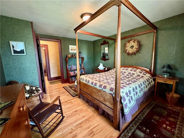 225 John Cook Rd, Unadilla, NY 13849 - bedroom with wallpapered walls and wood finished floors
