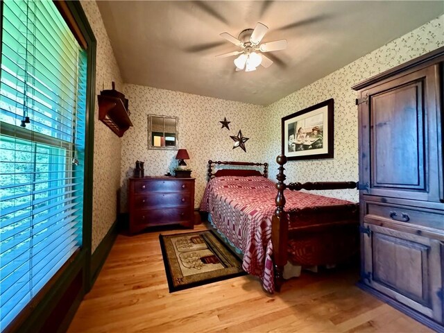 225 John Cook Rd, Unadilla, NY 13849 - bedroom with light wood-type flooring, wallpapered walls, and ceiling fan