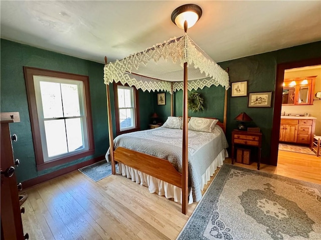 225 John Cook Rd, Unadilla, NY 13849 - bedroom with hardwood / wood-style flooring, baseboards, and ensuite bathroom