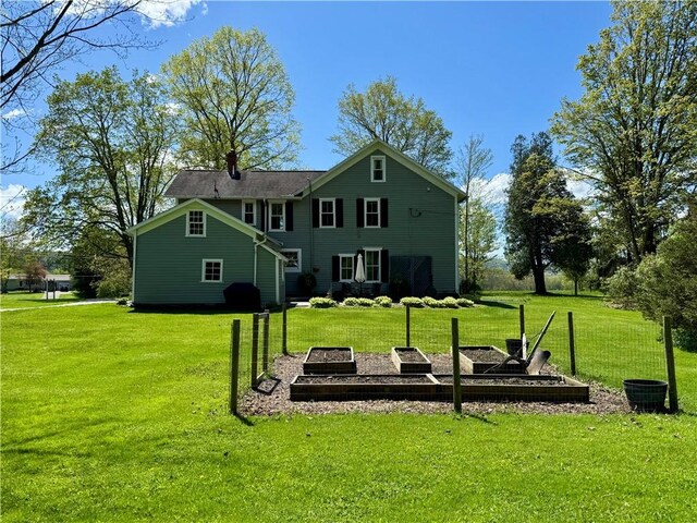 225 John Cook Rd, Unadilla, NY 13849 - rear view of property with a yard, a vegetable garden, and a chimney