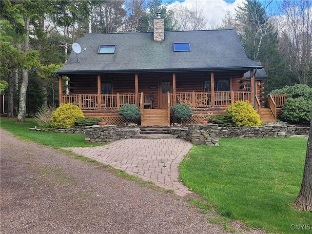 177 Woodchuck Run, Jefferson, NY 12093 - log cabin with log exterior, a porch, a chimney, and a front lawn