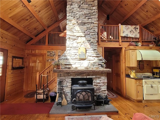 177 Woodchuck Run, Jefferson, NY 12093 - living area with light wood-style flooring, a wood stove, high vaulted ceiling, beam ceiling, and wood ceiling