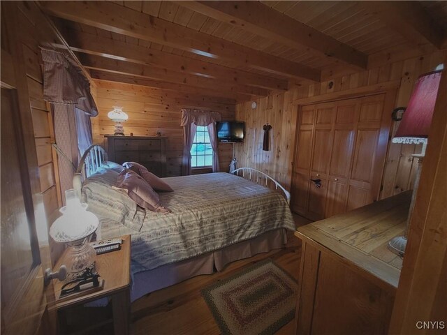 177 Woodchuck Run, Jefferson, NY 12093 - bedroom featuring beamed ceiling, wood ceiling, wooden walls, and wood finished floors