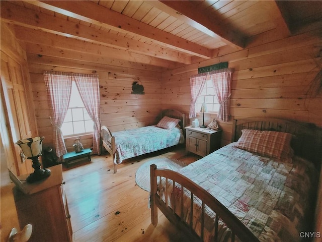 177 Woodchuck Run, Jefferson, NY 12093 - bedroom with beam ceiling, multiple windows, light wood finished floors, wood walls, and wood ceiling