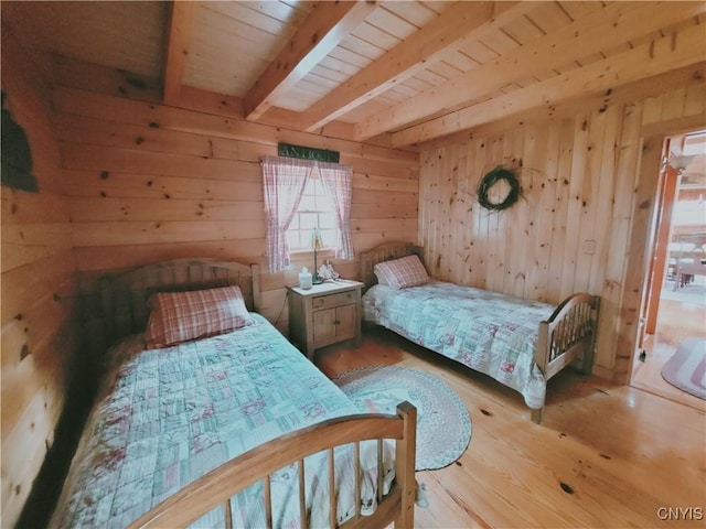 177 Woodchuck Run, Jefferson, NY 12093 - bedroom featuring beamed ceiling, wood finished floors, wood ceiling, and wood walls