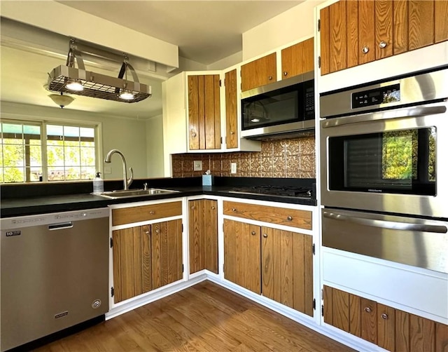 5 Orchard Dr, Corning, NY 14830 - kitchen with appliances with stainless steel finishes, a sink, a warming drawer, dark countertops, and dark wood-style floors