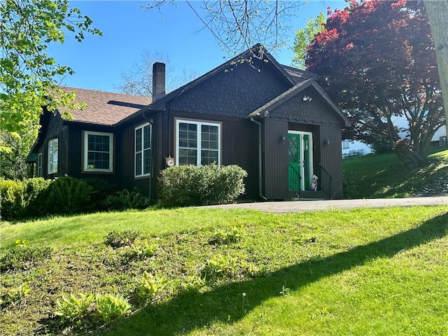 5 Orchard Dr, Corning, NY 14830 - view of front facade with a chimney, a front yard, and a shingled roof