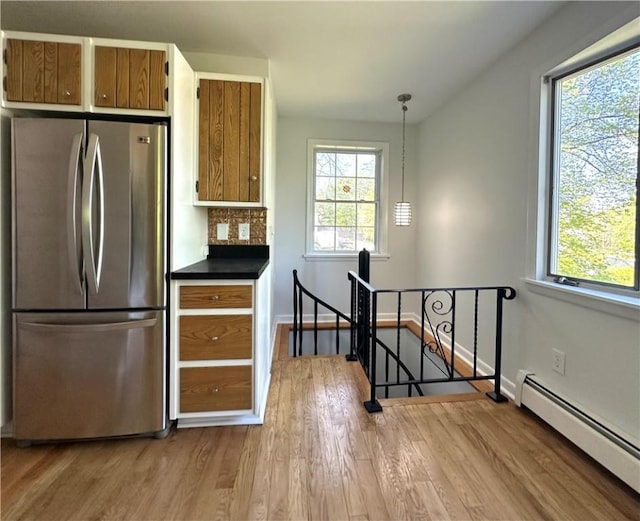 5 Orchard Dr, Corning, NY 14830 - kitchen featuring freestanding refrigerator, a baseboard heating unit, plenty of natural light, and light wood-type flooring