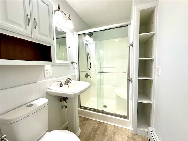 5 Orchard Dr, Corning, NY 14830 - bathroom featuring toilet, a stall shower, wood finished floors, and wainscoting