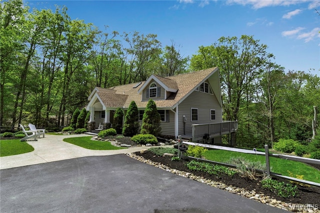 233 Falls Rd, Aurora, NY 14170 - view of front of home with asphalt driveway, fence, and roof with shingles