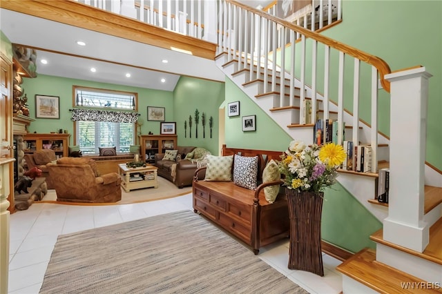 233 Falls Rd, Aurora, NY 14170 - tiled living area with a high ceiling, stairs, recessed lighting, and a fireplace