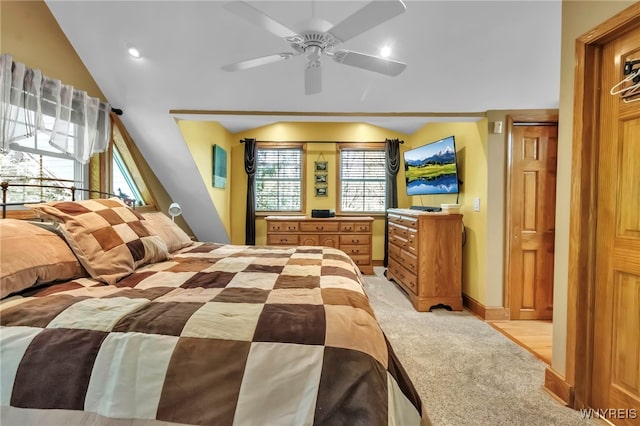 233 Falls Rd, Aurora, NY 14170 - bedroom featuring light carpet, multiple windows, vaulted ceiling, a ceiling fan, and baseboards