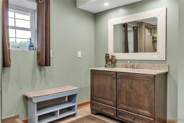 233 Falls Rd, Aurora, NY 14170 - bathroom featuring vanity, baseboards, and wood finished floors