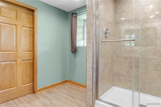 233 Falls Rd, Aurora, NY 14170 - bathroom featuring a shower stall, baseboards, and wood finished floors