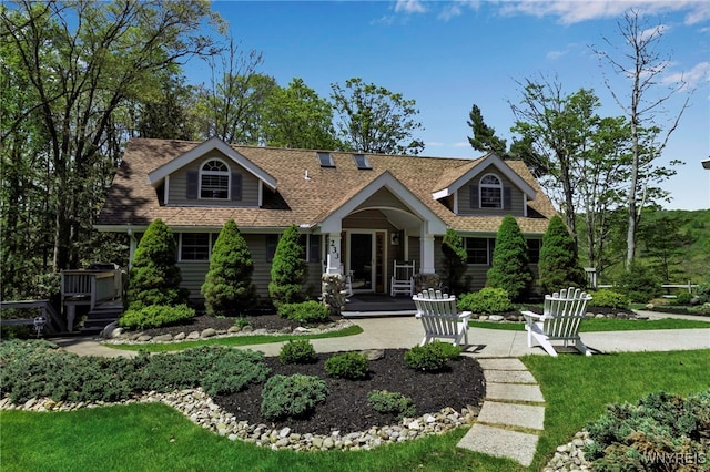 233 Falls Rd, Aurora, NY 14170 - view of front of home with a shingled roof, a front yard, and a porch