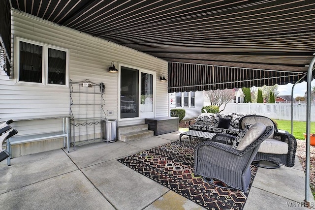 view of patio / terrace with fence, an outdoor living space, and entry steps