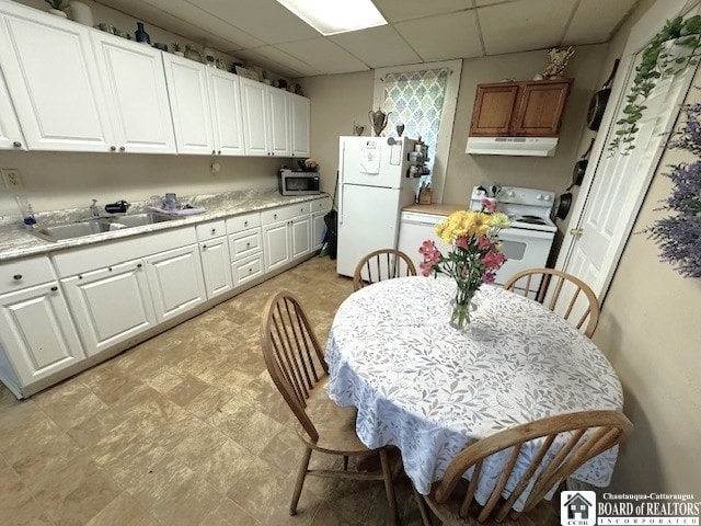 154 N Portage St, Westfield, NY 14787 - kitchen featuring under cabinet range hood, white appliances, a sink, light countertops, and a paneled ceiling