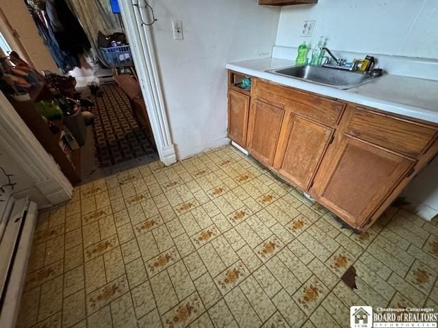 154 N Portage St, Westfield, NY 14787 - kitchen featuring a sink, brown cabinetry, light countertops, and light floors