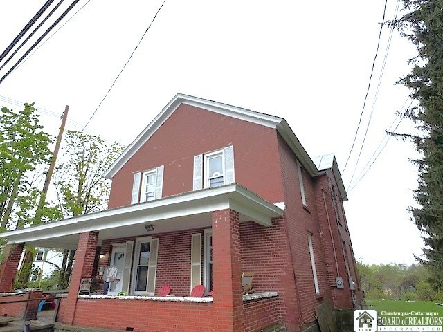 154 N Portage St, Westfield, NY 14787 - view of side of home featuring a porch and brick siding