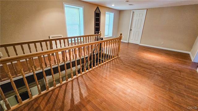 24 Grover St, Auburn, NY 13021 - hallway featuring an upstairs landing, wood finished floors, and baseboards