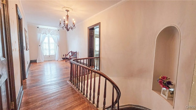 24 Grover St, Auburn, NY 13021 - hall with an upstairs landing, a chandelier, wood finished floors, and ornamental molding