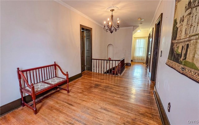 24 Grover St, Auburn, NY 13021 - hallway featuring an upstairs landing, a chandelier, wood finished floors, crown molding, and baseboards