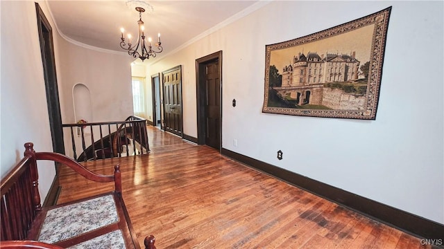 24 Grover St, Auburn, NY 13021 - hallway with an upstairs landing, a chandelier, wood finished floors, crown molding, and baseboards