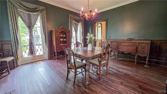 24 Grover St, Auburn, NY 13021 - dining area with wood finished floors, a chandelier, plenty of natural light, ornamental molding, and wainscoting