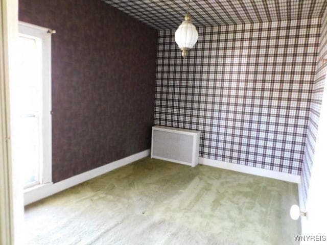 26 Robinson St, Hanover, NY 14136 - unfurnished dining area with carpet flooring, radiator, wallpapered walls, and baseboards