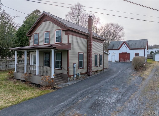 2795 State Route 12b, Marshall, NY 13328 - view of front facade featuring covered porch, a chimney, an outdoor structure, metal roof, and fence