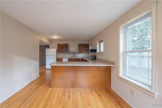 2795 State Route 12b, Marshall, NY 13328 - kitchen with white appliances, a sink, light countertops, a peninsula, and light wood finished floors