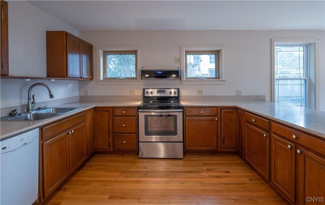 2795 State Route 12b, Marshall, NY 13328 - kitchen with electric stove, white dishwasher, a sink, ventilation hood, and brown cabinetry