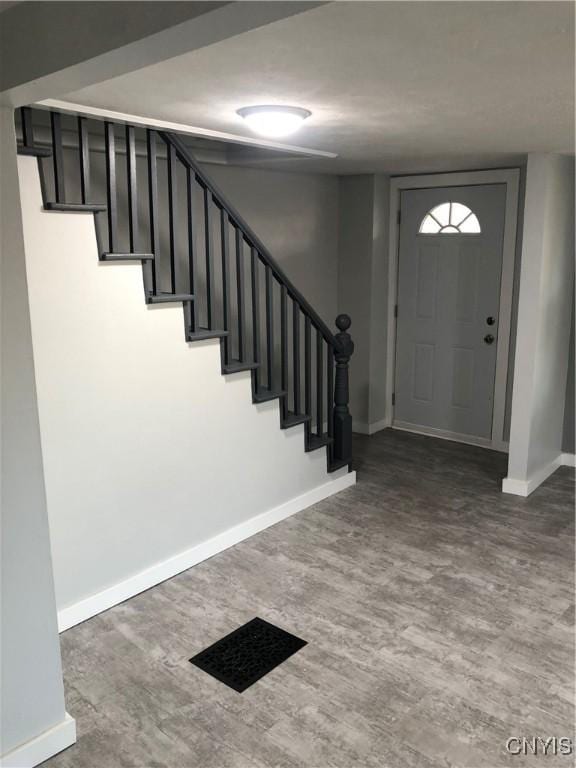 150 E Seneca St, Oswego-City, NY 13126 - entrance foyer with stairs, baseboards, and wood finished floors