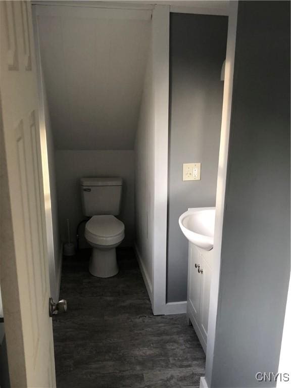 150 E Seneca St, Oswego-City, NY 13126 - half bath with toilet, wood finished floors, vanity, baseboards, and lofted ceiling
