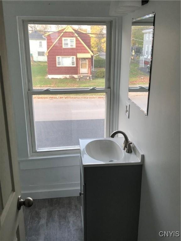 150 E Seneca St, Oswego-City, NY 13126 - bathroom featuring vanity and wood finished floors