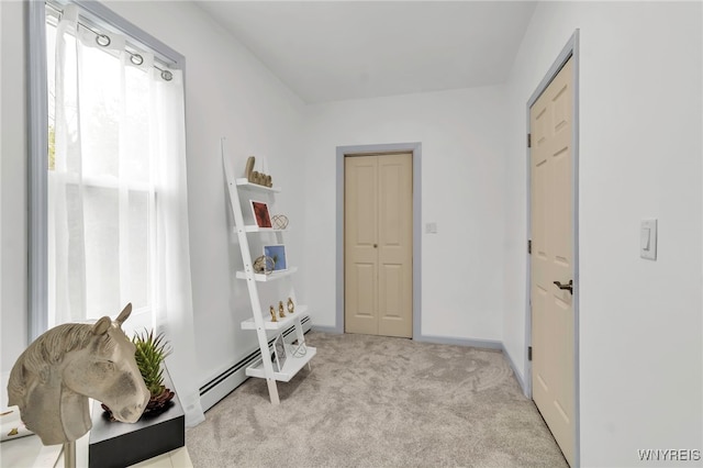 65 Kingsley St, Buffalo, NY 14208 - living area featuring a baseboard heating unit, light colored carpet, and baseboards