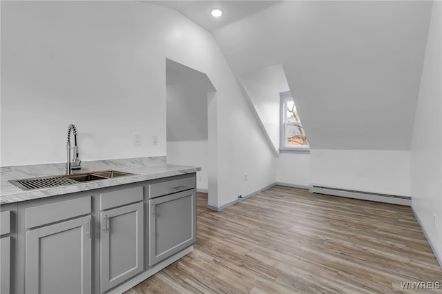 65 Kingsley St, Buffalo, NY 14208 - additional living space with a baseboard radiator, a sink, vaulted ceiling, light wood-type flooring, and baseboards