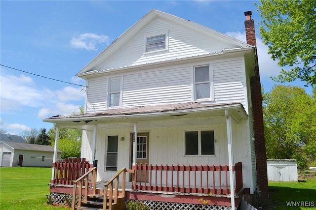 584 E Ave, Shelby, NY 14103 - view of front of house featuring a porch, a chimney, board and batten siding, and a front yard