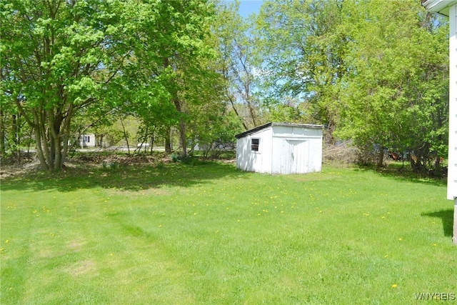 584 E Ave, Shelby, NY 14103 - view of grassy yard featuring a storage shed and an outdoor structure