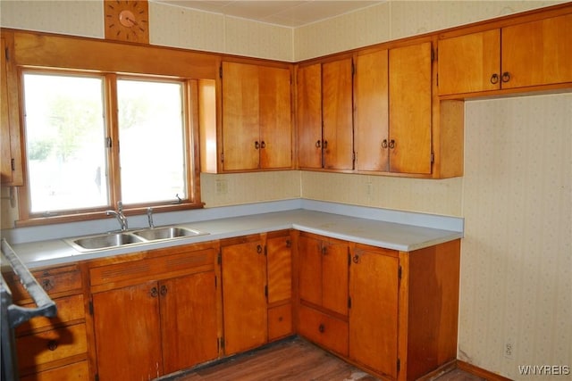 584 E Ave, Shelby, NY 14103 - kitchen with a sink, wallpapered walls, light countertops, brown cabinets, and wood finished floors