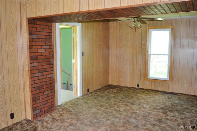 584 E Ave, Shelby, NY 14103 - spare room featuring healthy amount of natural light, carpet floors, wooden walls, and ceiling fan