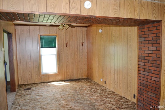 584 E Ave, Shelby, NY 14103 - spare room featuring carpet flooring and wooden walls