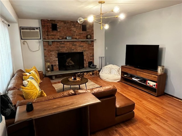 200 Torsten Ln, Davenport, NY 13750 - living room featuring a wall mounted air conditioner, wood finished floors, a chandelier, and a brick fireplace
