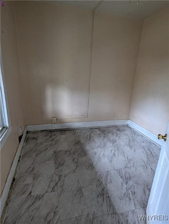 1706 Niagara St, Niagara Falls, NY 14303 - empty room featuring marble look tiles and baseboards