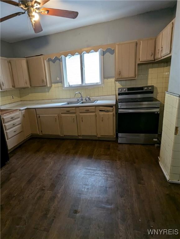 1706 Niagara St, Niagara Falls, NY 14303 - kitchen with stainless steel range with electric cooktop, a sink, dark wood-style flooring, light countertops, and decorative backsplash