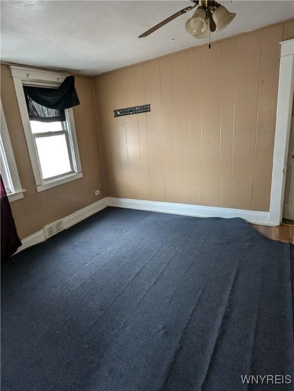1706 Niagara St, Niagara Falls, NY 14303 - empty room with a ceiling fan, dark carpet, and baseboards