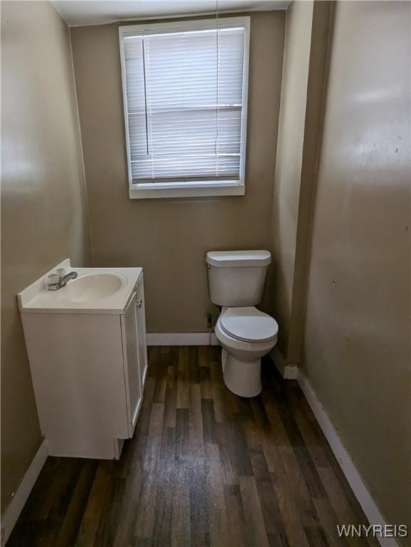 1706 Niagara St, Niagara Falls, NY 14303 - bathroom featuring wood finished floors, toilet, vanity, and baseboards
